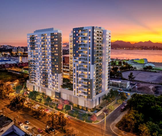 Fachada de dois edifícios residenciais modernos ao entardecer.